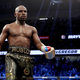 Floyd Mayweather Jr. walks to his corner while taking on Conor McGregor during their super welterweight boxing match on August 26, 2017 at T-Mobile Arena in Las Vegas, Nevada.